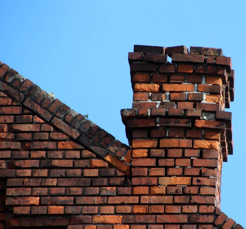 Damaged chimney on an Haslet home showing cracks and missing mortar